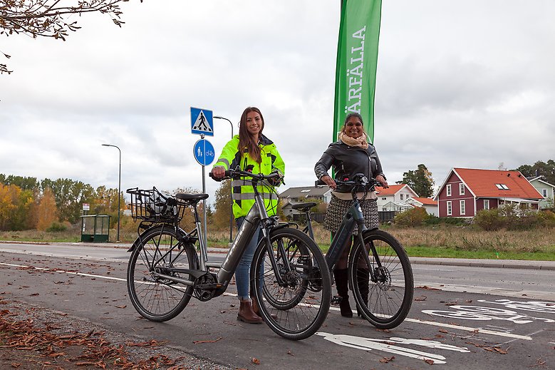 Joanna Saber, trafikplanerare, och kommunstyrelsens ordförande Emma Feldman poserar med cyklar vid den nya gång- och cykelbanan.